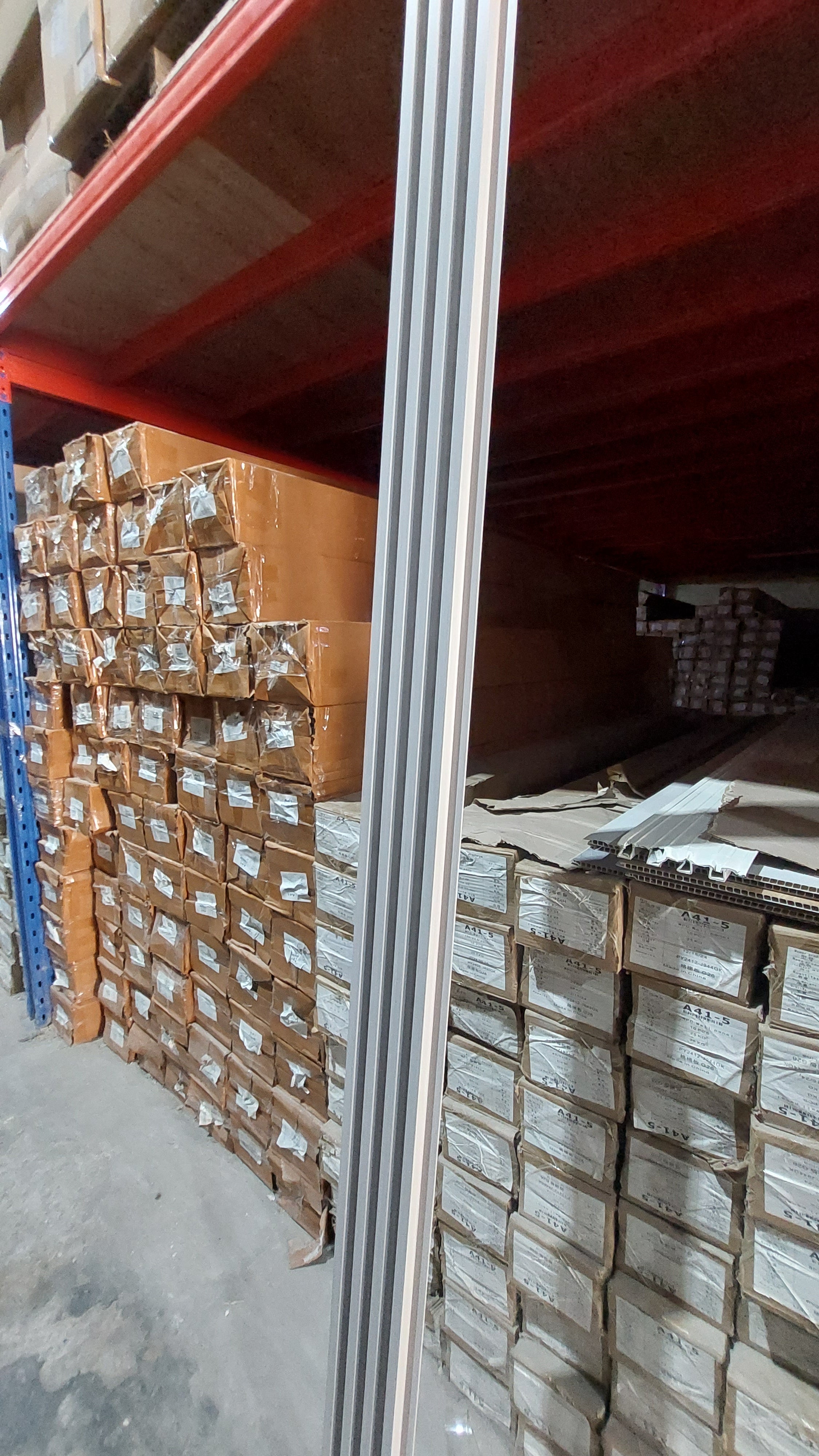 Stacks of cardboard boxes on a pallet in a warehouse setting