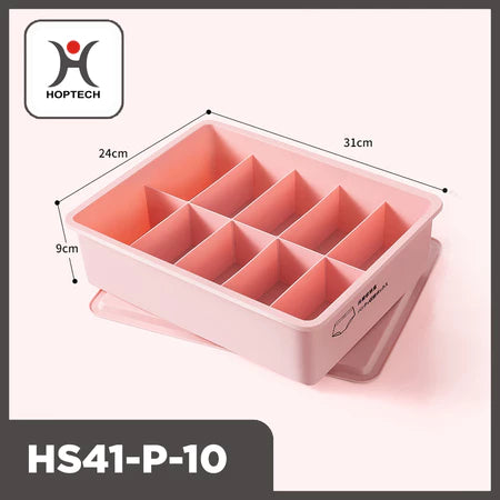ampilan tiga perempat dari organizer laci Hoptech HS41-P-10 berwarna merah muda pastel dengan 10 kompartemen terpisah dan penutupnya di bawah. Dimensi produk terlihat jelas: panjang 31cm, lebar 24cm, dan tinggi 9cm. Logo Hoptech berwarna merah dan hitam tertera di pojok kiri atas gambar."