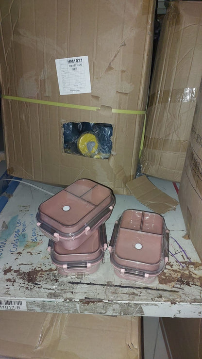 Brown plastic containers on a cardboard floor with a box in the background