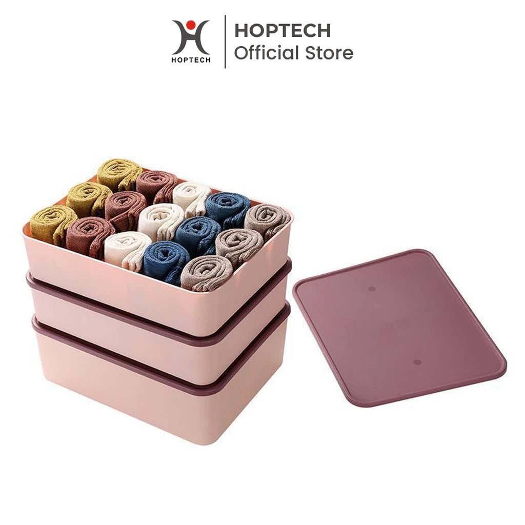 A set of Hoptech storage boxes in pink and purple colors, with one box open displaying rolled-up socks inside, and a lid placed beside it.
